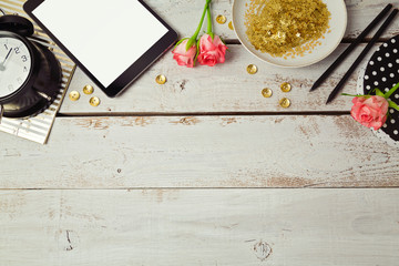 Website header design with digital tablet and rose flowers on wooden table. View from above