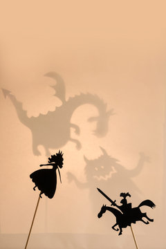 Shadow puppets of Princess and Knight, copy space background.