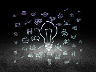 Business concept: Light Bulb in grunge dark room