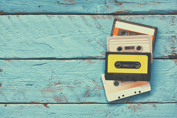 close up photo of vintage cassette tape over aqua wooden table . top view. retro filtered
