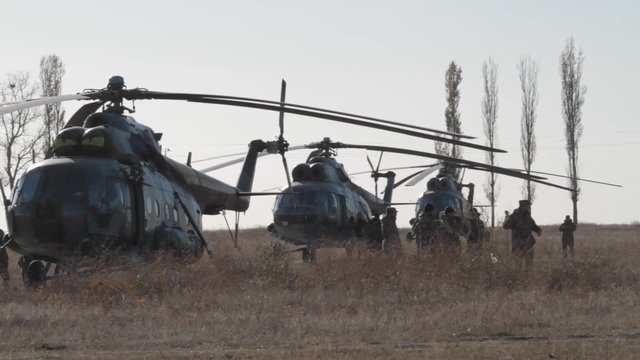 Military helicopters on the field. Three Mil Mi-8  Soviet-designed medium twin-turbine transport helicopters