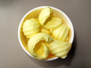 Yellow butter curls in a dish ready to be used