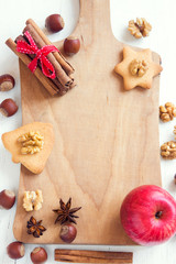 Fototapeta na wymiar Christmas spices, nuts on cutting board