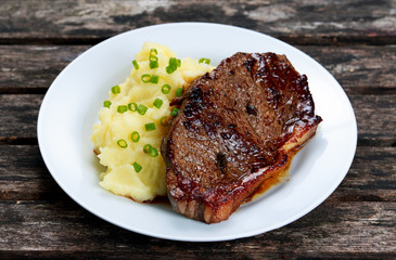 Rare beef steak with mashed potatoes