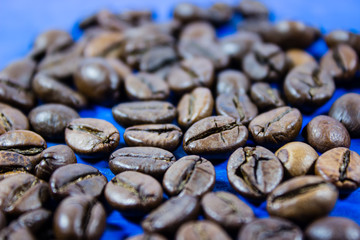 Coffee beans isolated on blue wooden background