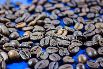 Coffee beans isolated on blue wooden background