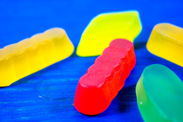 Multicolored jelly candies on blue wooden background