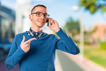 Men talking to mobile over isolated background.