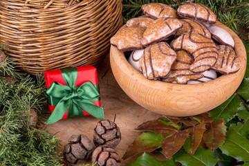 Christmas decoration with fir branches, mistletoe, wood cookies and gifts