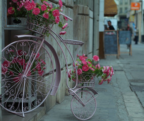 Fototapeta na wymiar City design: flower basket in the form of antic bicycle