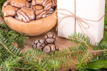 Christmas decoration with fir branches, mistletoe, wood cookies and gifts