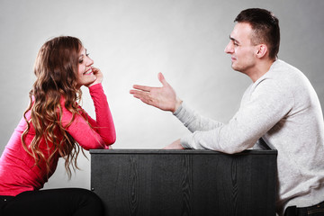 Man trying to reconcile with woman after quarrel.