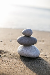 Fototapeta na wymiar Stacked stones on a natural background. zen bakcground