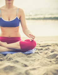 Yoga woman on sea coast