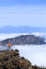 Fototapeta na wymiar young woman hiker hiking on beautiful mountain peak