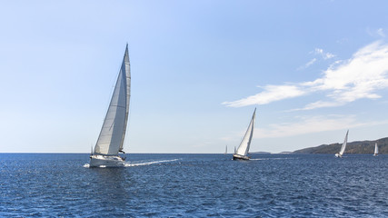 Fototapeta premium Sailing regatta. Sailing in the wind through the waves at the Aegean Sea in Greece.