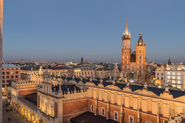 Fototapeta Krakow, Poland, Virgin Mary church on the Main Market Square seen over Sukiennice (Cloth Hall) from the Town Hall tower in the night obraz
