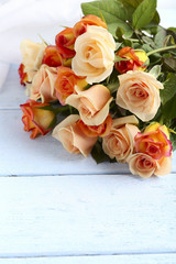 Bouquet orange roses on blue wooden background