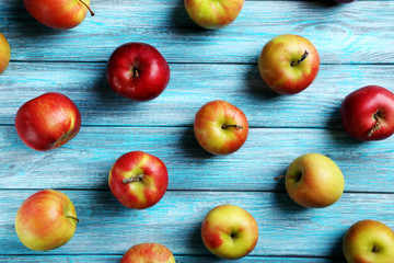 Fresh apples on a blue wooden table