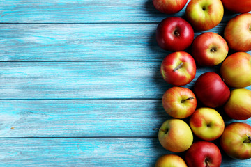 Fresh apples on a blue wooden table