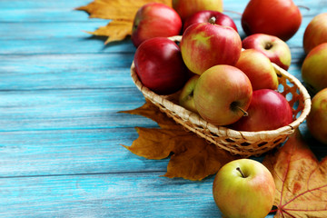 Fresh apples on a blue wooden table