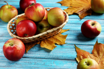 Fresh apples on a blue wooden table