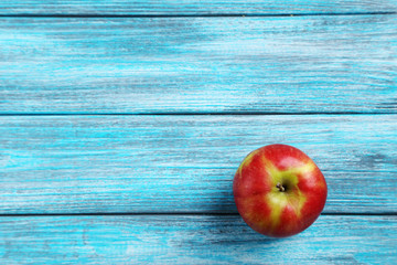 Fresh apple on a blue wooden table