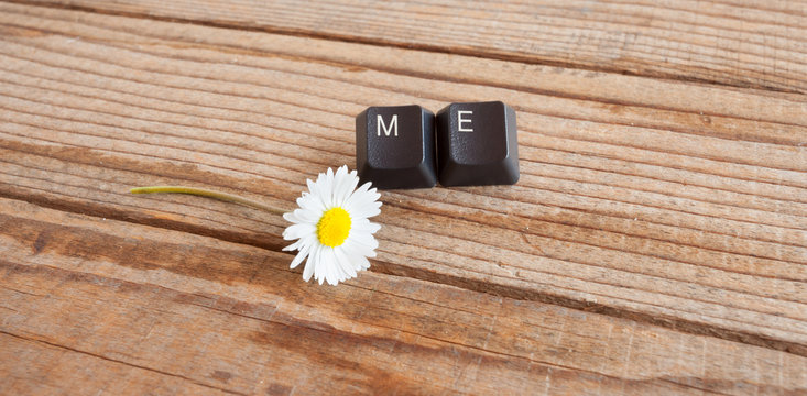"me" wrote with keyboard keys on wooden background