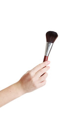 Female hand with brush for make-up isolated on white