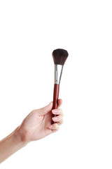 Female hand with brush for make-up isolated on white