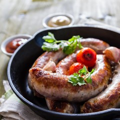 Grilled sausages on pan with herbs and spices
