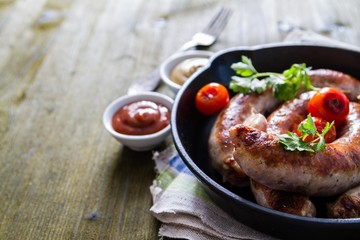 Grilled sausages on pan with herbs and spices