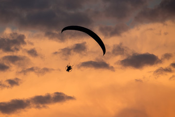 unidentified skydiver, parachutist on dramatic sky