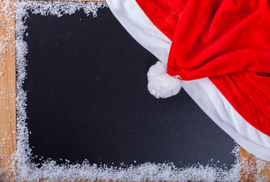 Christmas and New Year background. wooden Board with a red cap of Santa Claus.Copy space.selective focus.