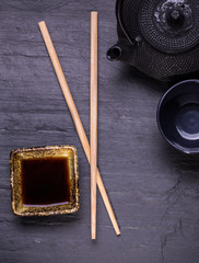 Asian teapot over wooden table. Top view with copy space