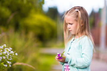 Little cute girl in summer park outdoors