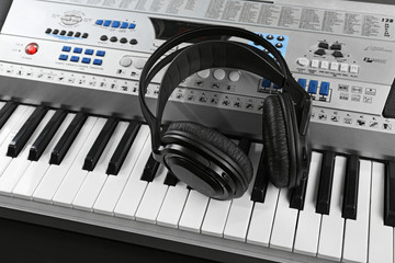 Headphones on synthesizer close up