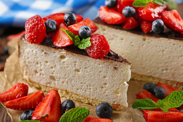 Delicious cheesecake with berries on table close up