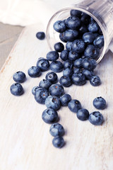 Fresh blueberries in glass on wooden table close up