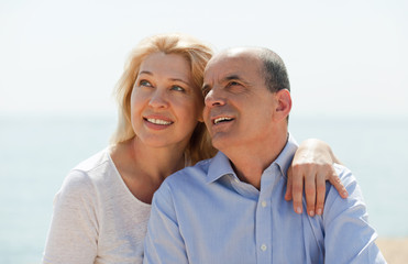 loving eldelry couple at sea on holiday smiling