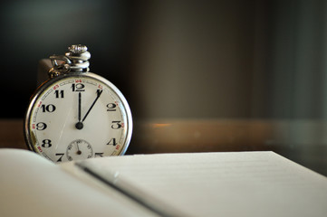 Pocket watch next to notebook. symbols of time