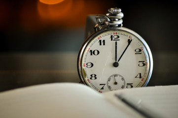Pocket watch next to notebook. symbols of time 