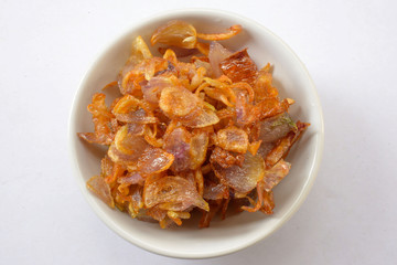 crispy fried onion flakes on white background