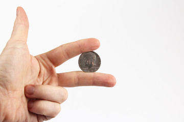 fingers of the hand holding the coin