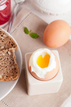 boiled egg, bread and jam for breakfast, vertical, close-up