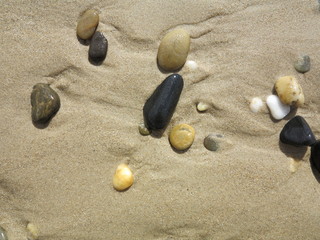 Fototapeta na wymiar Stones on sand