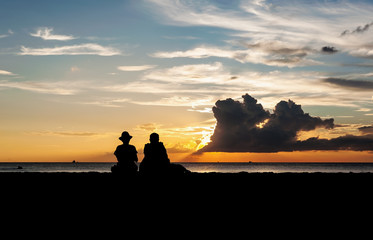Silhouette of lovers relax on the beach