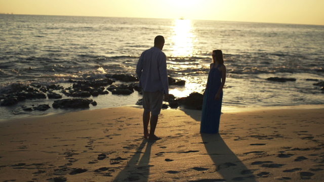Young couple breaking up on beach and walking away, super slow motion 240fps
