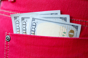 Dollar banknotes in jeans pocket closeup