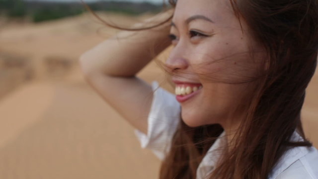 Asian woman smile outdoor desert wind blowing hair